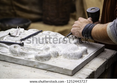 Carving stone in a traditional way, craftsmanship detail, shaping the stone Royalty-Free Stock Photo #1252443727