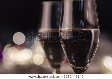 
New Year. Glasses with champagne. New Year on the table are glasses of champagne and in the background is a beautiful bokeh. New year happy mood.