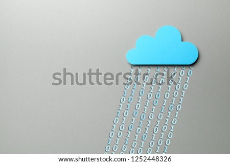 Cloud storage. Personal and business information is stored online in the cloud. Blue cloud and binary code in the form of rain. Copy space for text