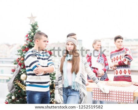 Young friends celebrating Christmas on balcony