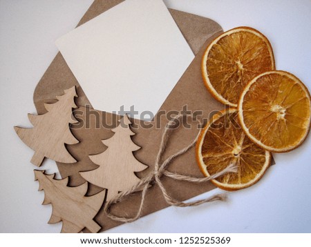 wooden Christmas trees, envelope and dried orange slices on a white background. congratulation. minimalist design