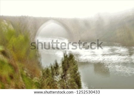 S. Martin bridge, Tribute to Monet, impressionist photograph of the road next to the Tagus River in Toledo, Spain, in Autumn with fog, photographic sweeps at low shutter speed, Don Quixote route,