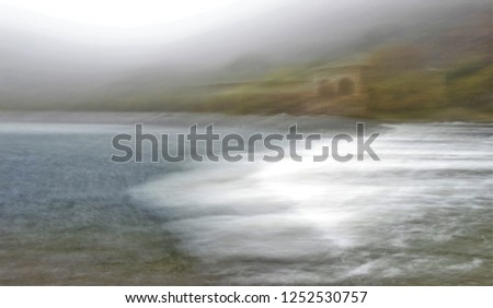 river mill, Tribute to Monet, impressionist photograph of the road next to the Tagus River in Toledo, Spain, in Autumn with fog, photographic sweeps at low shutter speed, Don Quixote route,