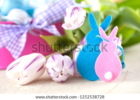 Easter eggs and tulips on wooden planes..German text happy easter