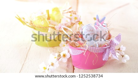Easter eggs and tulips on wooden planes..German text happy easter