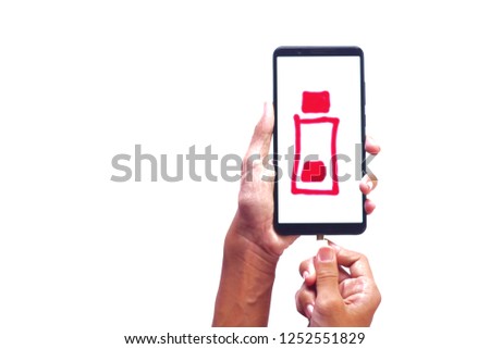 Black smart phone with charging screen and charger in hand isolated over white background.