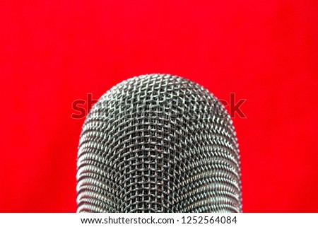 Vocal audio microphone on a red background