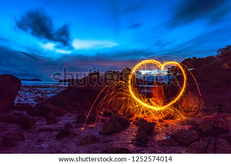 heart image from steel wool on the rock at sunrise