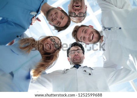 doctors looking down smiling at the camera