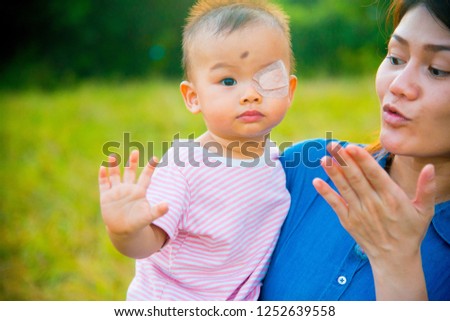 Asian female model and asian baby pose for pictures in the nature