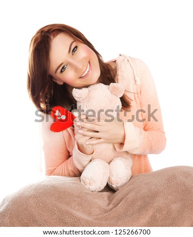 Picture of pretty woman with soft bear toy in bed, sweet young lady received gift for Valentine day, lovely brunette teen girl with romantic present isolated on white background, love concept