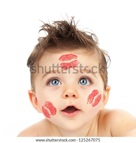 Picture of small cute Cupid, closeup portrait of pretty child with red kisses on his cheeks isolated on white background, curious little boy with beautiful blue eyes looking in camera, Valentine day
