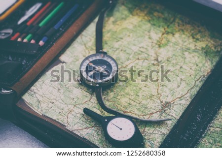 odometer in focus. military commander's bag with a compass. map for the route. there is toning.