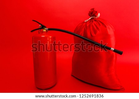 santa bag and fire extinguisher isolated red background