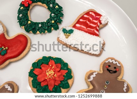 Traditional christmas cookies with different shapes: santa hat and boot, christmas wreath, happy man... Homemade biscuits with festive decoration.