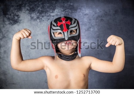 Portrait of a young boy with a wrestler mask