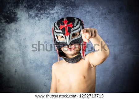 Portrait of a young boy with a wrestler mask