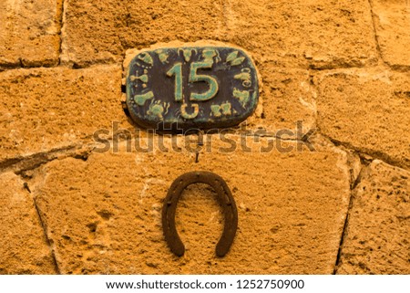 Horseshoe on the wall with number fifteen
