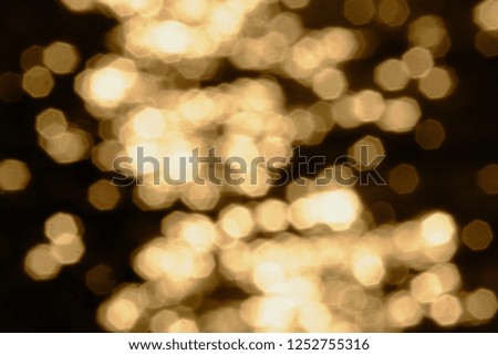 Golden bokeh light in the dark night with black background 