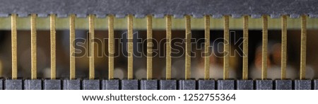 Close up (Macro) of Printed Circuit Board PCB embedded components (inductors, resistors, capacitors, diodes, microchips, transistor) with short depth of view. 
