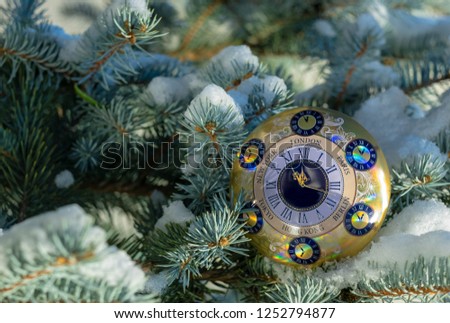 Happy new year and merry christmas, christmas background alarm-clock on the christmas tree. Greeting card the end of the year, year-end, alarmclock, timer, timepiece.