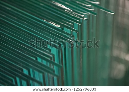 A lot of glass panes in one place. Glass factory. Royalty-Free Stock Photo #1252796803