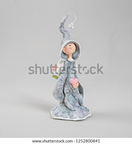 Handmade ceramic figurines of little angels isolated on white background