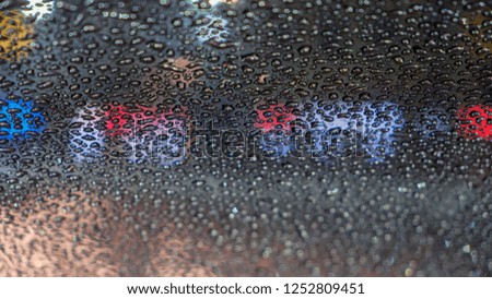 Raindrops on car glass at night