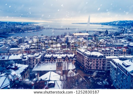 Snowing in Geneva during Winter before Christmas - Photo taken from the top of the cathedral with a view of the famous harbor of Geneva as the first snow falls on the city.
