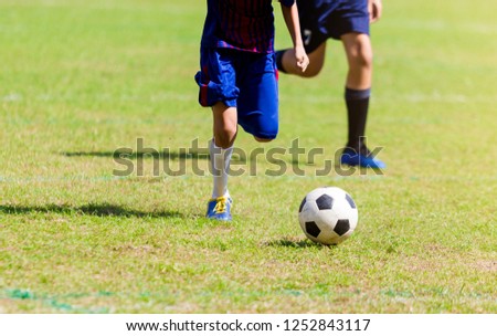 Soccer players run to trap and control the ball for shoot to goal. Soccer players fighting each other by kicking the ball