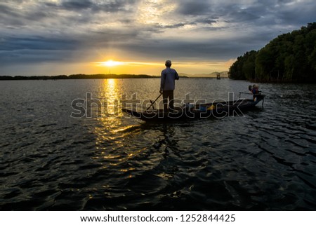 Fisherman silhouette at sunset 