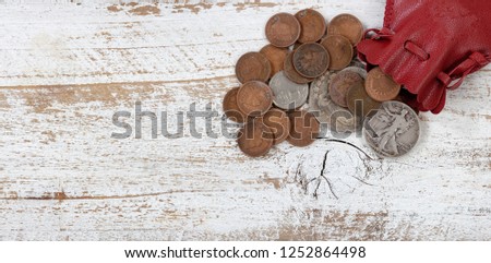 Bag of vintage United States coins on white rustic wood