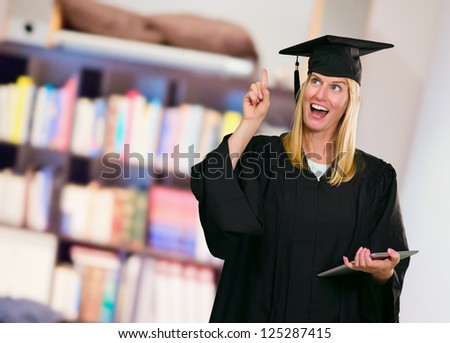 Graduate Woman Holding Digital Tablet at a library