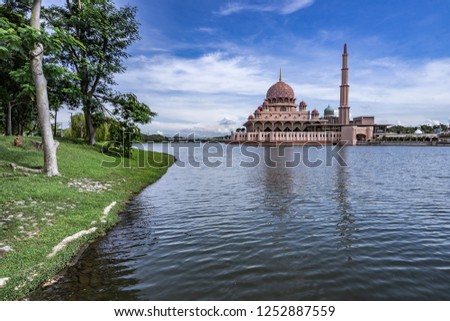 Putra Mosque or pink masjid in Putrajaya during morning time with blue sky, Malaysia.