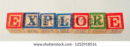 The term explore visually displayed on a white background using colorful wooden blocks image in landscape format