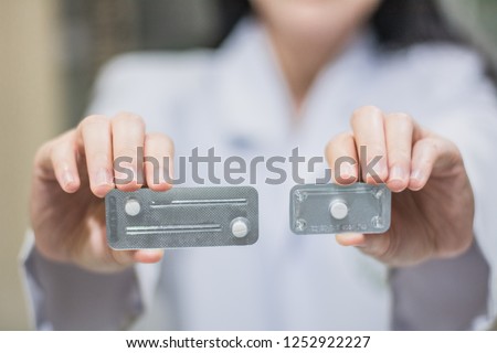 A hand holding emergency contraception (morning after pill) packs. Royalty-Free Stock Photo #1252922227