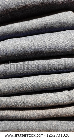Close up of stack of blue jeans, clothes background