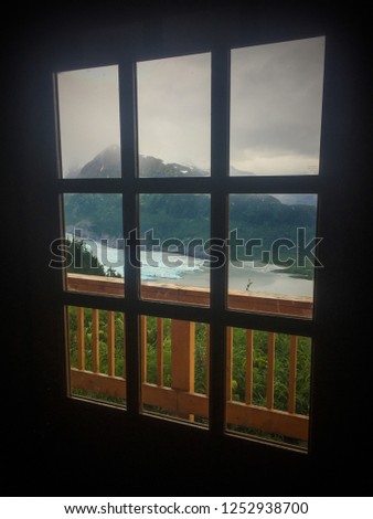 Beyond the window lies a glacier view. Royalty-Free Stock Photo #1252938700