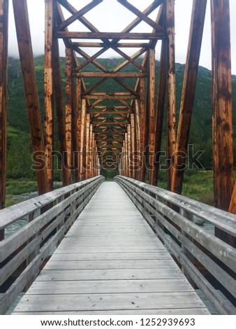 Following the bridge over the river. Royalty-Free Stock Photo #1252939693
