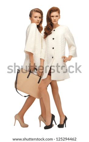 picture of two teenage girls in white coats with bag