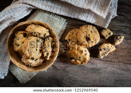 Cookies in weave bowl on rustic wooden table, Top view.