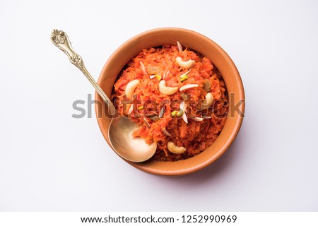 Gajar ka halwa is a carrot-based sweet dessert pudding from India. Garnished with Cashew/almond nuts. served in a bowl. Royalty-Free Stock Photo #1252990969