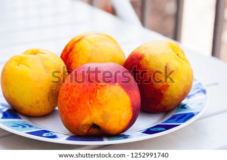 Fresh ripe peaches on the plate