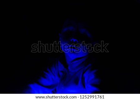 Portrait of a child in blue light