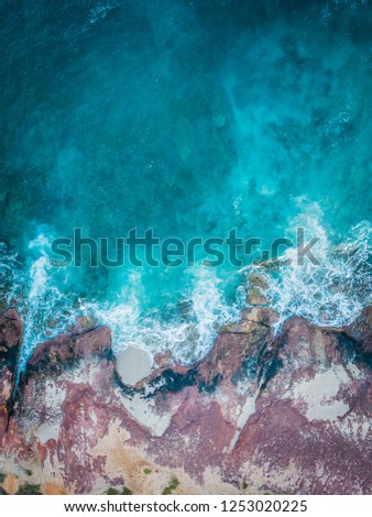 Waves with blue water with rocky coastline in Kalbarri Western Australia.