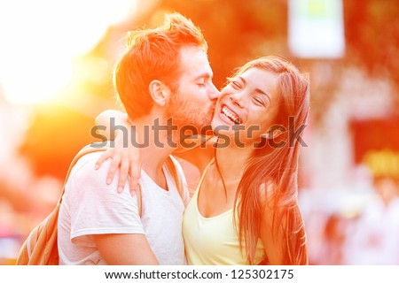 Couple kissing happiness fun. Interracial young couple embracing laughing on date. Caucasian man, Asian woman on Manhattan, New York City, USA.