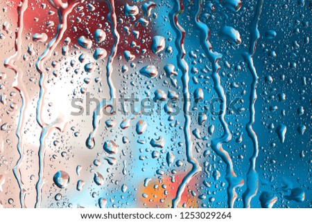 Water drops or rain droplets on glass