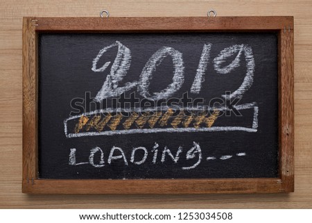 2019 loading with progress bar, chalk drawing on blackboard