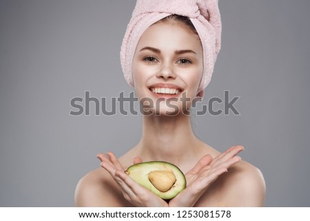 Smiling woman holding avocado                       