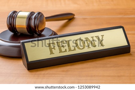 A gavel and a name plate with the engraving Felony Royalty-Free Stock Photo #1253089942